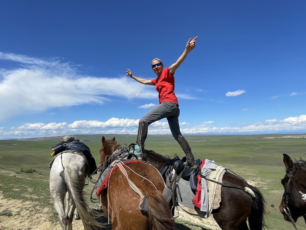 Audrey Bogini on top of horses during Horseriding Georgia trip across a semi-desert area near Udabno.  